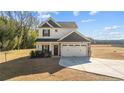 Two-story house with gray and white siding, two-car garage, and landscaped yard at 1264 Hayes Rd, Spring Lake, NC 28390