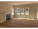 Spacious living room includes a fireplace and multiple windows at 6935 Old Jefferson Davis Hwy, Cameron, NC 28326