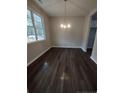 Simple dining room with dark hardwood floors and a chandelier at 788 Roberts Rd, Sanford, NC 27332
