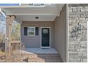 Home features a welcoming front porch and a dark blue door at 886 Juno Dr, Broadway, NC 27505