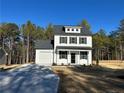 Two-story farmhouse style home with white siding, black shutters, and a gray roof at 806 Roberts Rd, Sanford, NC 27332