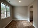 Simple dining room with hardwood floors and large window at 826 Roberts Rd, Sanford, NC 27332