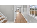 Bright hallway with hardwood floors and a staircase leading to upper level, flooded with natural light at 912 Allstar Ave, Cameron, NC 28326