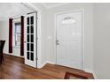 Bright foyer featuring hardwood floors and a paneled glass door at 58 Bayleaf Ln, Sanford, NC 27332