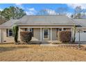 Inviting front entrance with manicured shrubbery and an attached two-car garage at 58 Bayleaf Ln, Sanford, NC 27332
