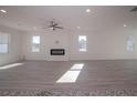 Open living room with hardwood floors and a modern fireplace at 246 Tormore Dr, Sanford, NC 27330