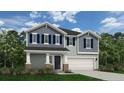 Inviting two-story home showcases stylish gray siding, blue shutters, and a manicured front lawn at 3 Bennington Way, Lillington, NC 27546