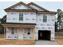 New construction two-story home featuring black roof, covered front porch and one car garage at 4 Bennington Way, Lillington, NC 27546