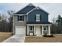 Beautiful two-story home with a covered front porch, attached garage, and well-manicured lawn at 43 Bennington Way, Lillington, NC 27546