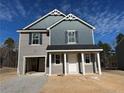 Two-story home with gray siding, a covered entryway, and an attached one-car garage at 43 Bennington Way, Lillington, NC 27546