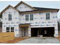 New construction home featuring a two-story design and an attached garage awaiting its finishing touches at 9 Bennington Way, Lillington, NC 27546