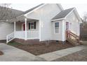 Front entrance with red door and white railings at 357 Juno Dr, Broadway, NC 27505
