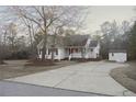 House exterior with a large driveway, landscaping, and a shed in the backyard at 357 Juno Dr, Broadway, NC 27505