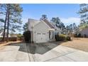 Charming home featuring manicured landscaping, a single-car garage, and a welcoming front entrance at 696 Valley Oak Dr, Bunnlevel, NC 28323