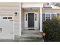 View of the front door, garage and manicured bushes at 696 Valley Oak Dr, Bunnlevel, NC 28323