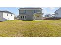 Expansive backyard view showcasing ample green space and the rear exterior of a well-maintained home at 51 Steeple Rdg, Cameron, NC 28326