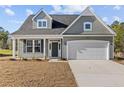 Inviting single-Gathering home featuring a two-car garage, well-kept lawn, and classic architectural details at 51 Steeple Rdg, Cameron, NC 28326