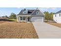 Beautiful single-Gathering home boasting a spacious two-car garage, pristine lawn, and traditional design elements at 51 Steeple Rdg, Cameron, NC 28326