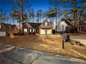 Night view of house exterior, two-car garage, and mailbox at 85 Shining Water Ln, Spring Lake, NC 28390