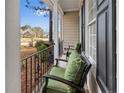 Front porch with two green cushioned chairs at 85 Shining Water Ln, Spring Lake, NC 28390