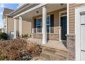 Inviting front porch with stone accents and sturdy columns, creating an appealing entry at 137 Falls Creek Dr, Spring Lake, NC 28390