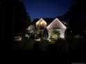 Two-story home with nighttime exterior lighting at 14 Old Pine Ct, Spring Lake, NC 28390