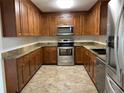 Bright kitchen with wood cabinets and stainless steel appliances at 307 Westfield Dr, Dunn, NC 28334