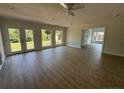 Spacious living room boasts beautiful hardwood floors, a ceiling fan, and multiple windows with outdoor views at 307 Westfield Dr, Dunn, NC 28334