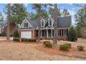 Two-story brick home with gray accents and mature trees at 60 Rolling Pines Dr, Spring Lake, NC 28390