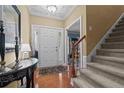Inviting foyer with hardwood floors, staircase, and decorative accents at 60 Rolling Pines Dr, Spring Lake, NC 28390
