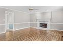 Living room featuring hardwood floors, a fireplace, and neutral color palette at 1003 Kelly Dr, Nashville, NC 27856