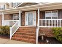 Brick front porch with white railings and steps leading to the entrance at 105 Caldwell St, Spring Lake, NC 28390