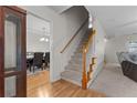 Bright entryway with staircase leading upstairs and a view of the dining room at 105 Caldwell St, Spring Lake, NC 28390