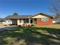 Attractive home featuring a brick facade, well-manicured lawn, and a convenient carport at 108 George St, Dunn, NC 28334