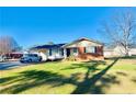 Front view of a brick ranch house with a yard at 108 George St, Dunn, NC 28334