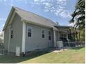 Gray house with covered patio, spacious backyard, and a fenced area at 224 Melody Ln, Cameron, NC 28326