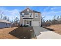 Two-story house with gray and beige siding, attached garage, and driveway at 28 York Ct, Spring Lake, NC 28390