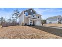 Two-story house with gray and beige siding, attached garage, and driveway at 28 York Ct, Spring Lake, NC 28390