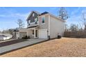 Two-story house with gray and beige siding, attached garage, and driveway at 28 York Ct, Spring Lake, NC 28390