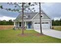Well-maintained one-story home with green lawn and charming exterior details on a sunny day at 2919 Lemuel Black Rd, Bunnlevel, NC 28323