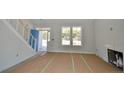 Bright living room featuring hardwood floors and a fireplace at 2919 Lemuel Black Rd, Bunnlevel, NC 28323