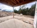 Covered patio with a view of a wooded area and other houses under construction at 67 Steeple Ridge (Lot 466), Cameron, NC 28326