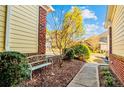 Peaceful walkway between brick buildings with a metal bench and landscaping at 82 Pine Hawk Dr, Spring Lake, NC 28390