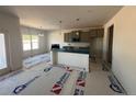 Bright kitchen featuring an island with a blue countertop and gray cabinets at 17 Tackett Ct, Lillington, NC 27546