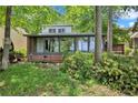 Brick house exterior with a sunroom and lush landscaping at 368 Cardinal Bay, Sanford, NC 27332