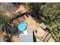 Aerial view of property showing in-ground pool with fenced yard and mature trees at 511 Providence Hall Dr, Sanford, NC 27330