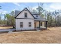 New construction home with white siding, black accents, and a tidy lawn at 1185 Cameron Hill Rd, Cameron, NC 28326