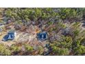 Aerial view of two new homes nestled in a wooded lot at 1221 Cameron Hill Rd, Cameron, NC 28326