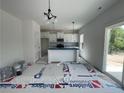 Bright kitchen features white cabinets, a center island, stainless appliances and plenty of natural light at 24 Tackett Ct, Lillington, NC 27546