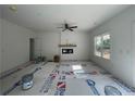 Bright living room features a modern fireplace, ceiling fan, and large windows at 39 Tackett Ct, Lillington, NC 27546